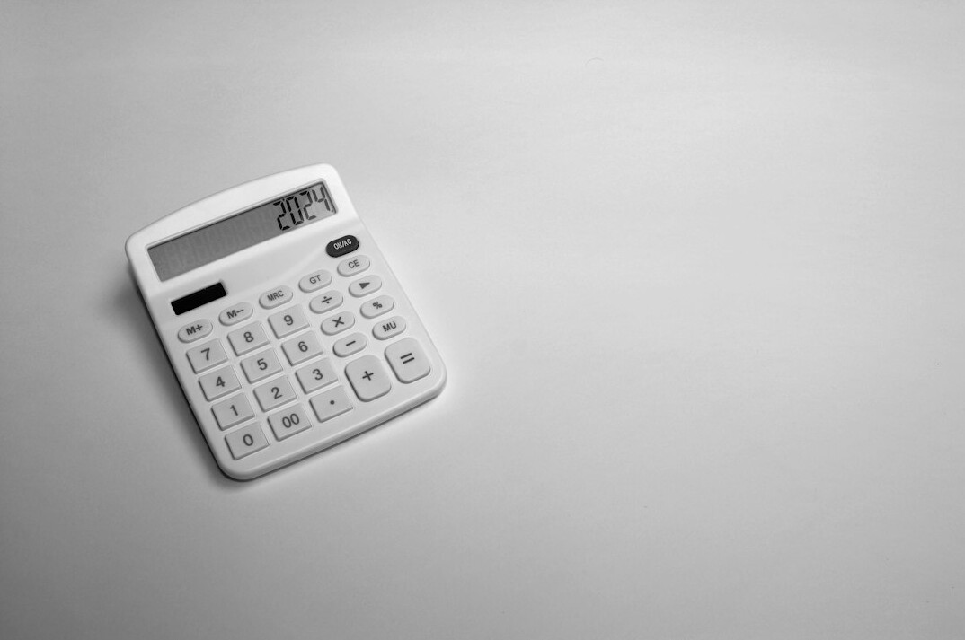 Close-up of financial statements, calculator and pen on a desk